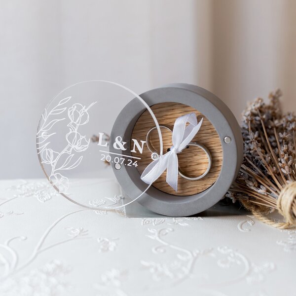 Charming gray gypsum ring box with oak insert, magnetic glass panel, and ribbon to hold rings. Customizable engagement ring holder for weddings.