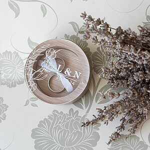 White wooden wedding ring box with magnetic glass panel and ribbon to hold rings. Elegant and stylish ring holder for weddings.