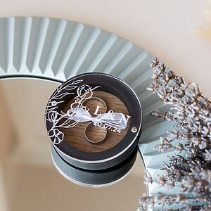 Custom black gypsum ring box with natural oak insert, magnetic glass lid, and ribbon ring holder. Elegant and personalized design for secure ring presentation.