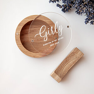 Open round oak dog hair keepsake box showing the smooth interior and personalized UV-printed acrylic lid with the name Girly.