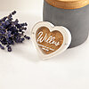Personalized white heart dog hair keepsake box with Willow UV-printing next to a grey concrete urn.